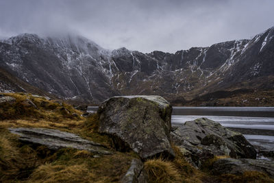 Scenic view of lake against mountain during winter