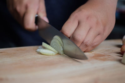Close-up of man preparing food on cutting board