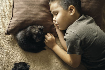 Boy sleeping with kitten. child and cat. kids and pets.  little boy with pet. boy and kitty sleep.