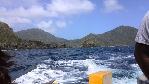 Scenic view of sea and mountains against sky