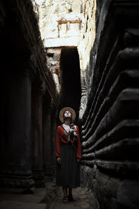 Rear view of woman walking in abandoned building