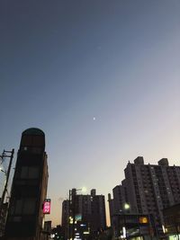 Low angle view of buildings against sky at night