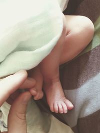 Extreme close up of hand holding baby feet