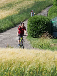 Man riding bicycle on field