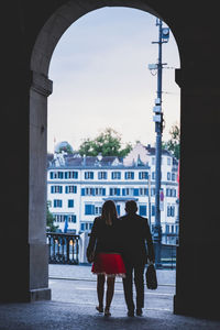 Rear view of people standing in city