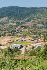 High angle view of houses amidst trees and buildings