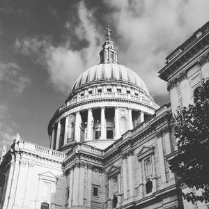 Low angle view of st pauls cathedral against cloudy sky on sunny day