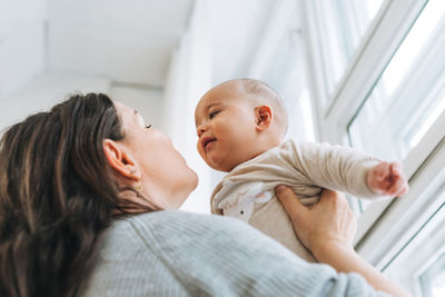 Mother and daughter baby on bed