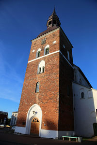 Low angle view of bell tower against blue sky