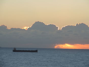 Scenic view of calm sea at sunset
