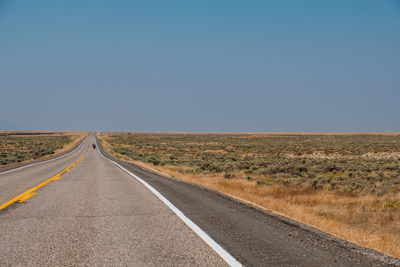 Road amidst landscape against clear sky