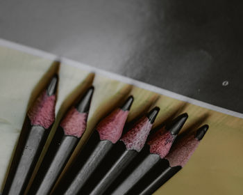 Close up of black pencils isolated on colourful background.