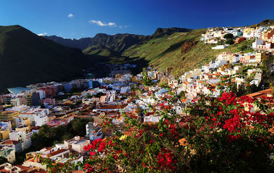 Residential district on mountain at san sebastian de la gomera against blue sky