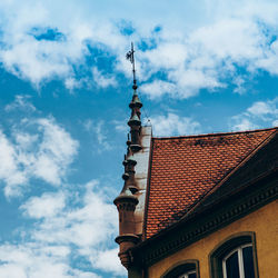 Low angle view of building against cloudy sky