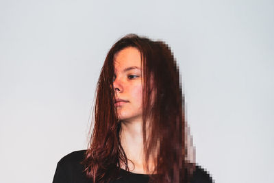 Portrait of young woman against white background