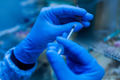 Cropped hand of doctor holding syringe