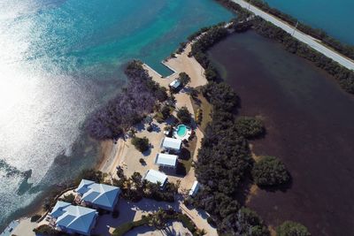 High angle view of swimming pool by sea against buildings