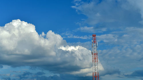 Low angle view of communications tower against blue sky