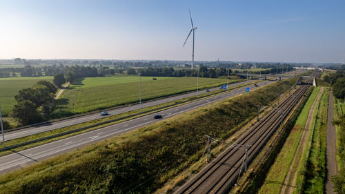 Panoramic view of railroad tracks on field against sky