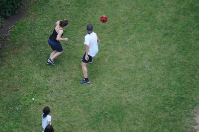 Girl playing soccer on grassy field