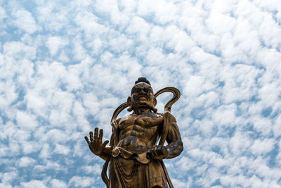 Low angle view of statue against sky