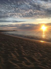 Scenic view of beach against sky during sunset