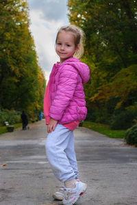 Portrait of young woman walking on road