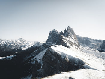 Scenic view of snowcapped mountains against clear sky