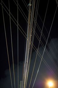 Low angle view of illuminated bridge against sky at night