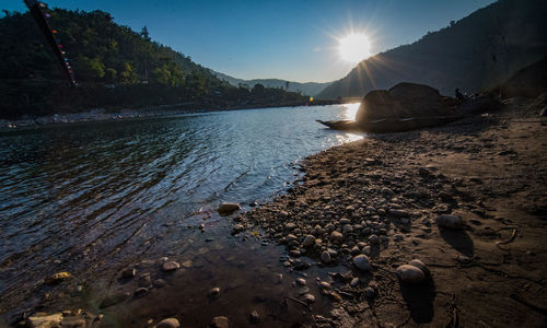 Scenic view of lake against sky at sunset