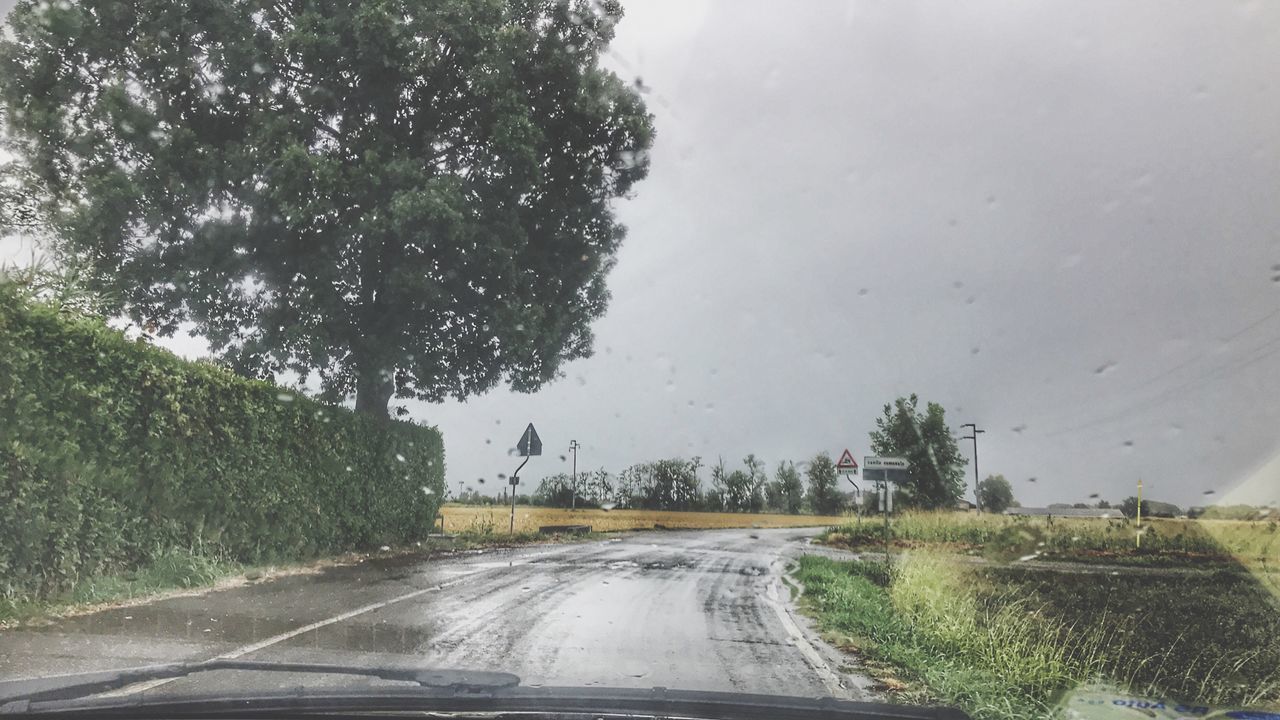 ROAD SEEN THROUGH WET WINDSHIELD