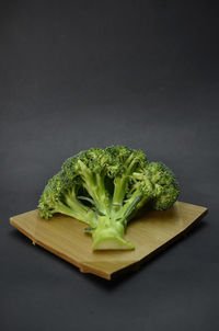 Close-up of vegetables on cutting board against black background