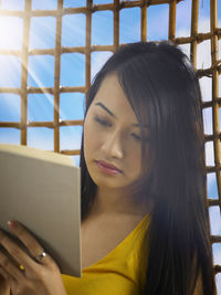 Close-up of young woman using smart phone