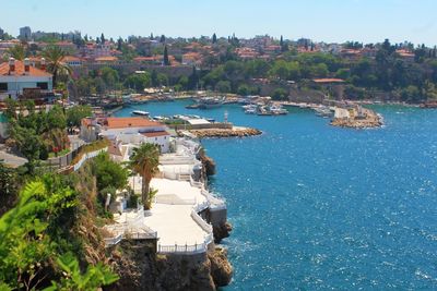 High angle view of town by sea against clear sky