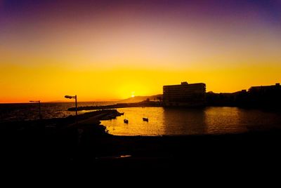 Scenic view of sea against orange sky