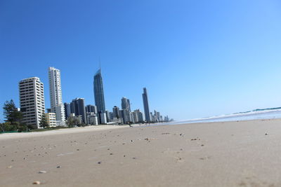 Panoramic view of beach and buildings against clear sky