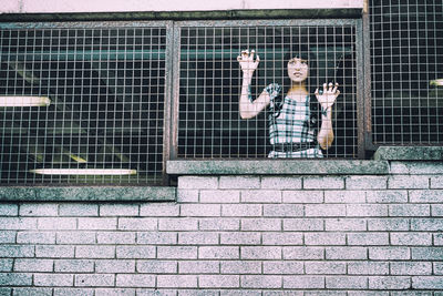 Portrait of man standing against wall