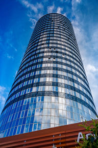 Low angle view of modern building against blue sky