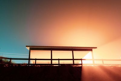 Silhouette built structure against sky during sunset