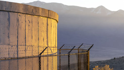 Built structure by mountain against sky