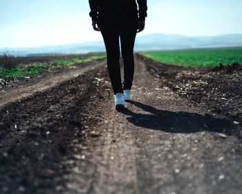 Low section of person standing on landscape