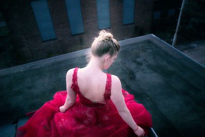 Rear view of woman on floor