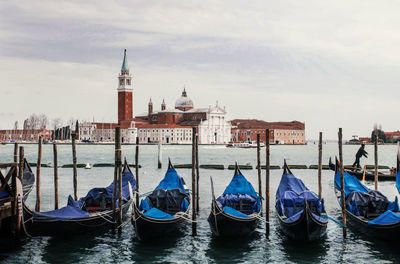 Boats moored on sea against sky