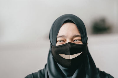 Close-up of young woman covering face