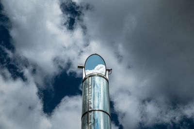 Low angle view of tower against cloudy sky