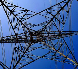 Low angle view of electricity pylon against sky