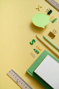 High angle view of school supplies on table