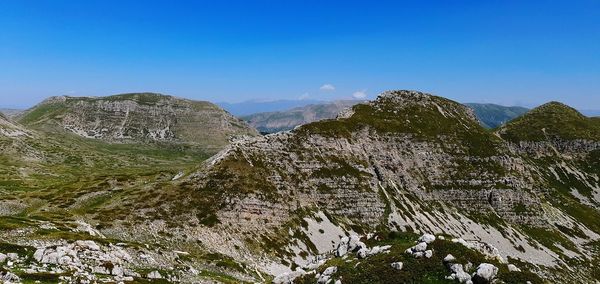 Scenic view of mountains against clear blue sky