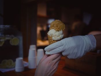 Close-up of hand holding ice cream