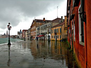 Wet street and buildings in city